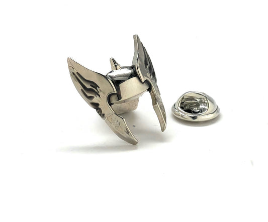 Metallic bird-shaped lapel pin on a white background