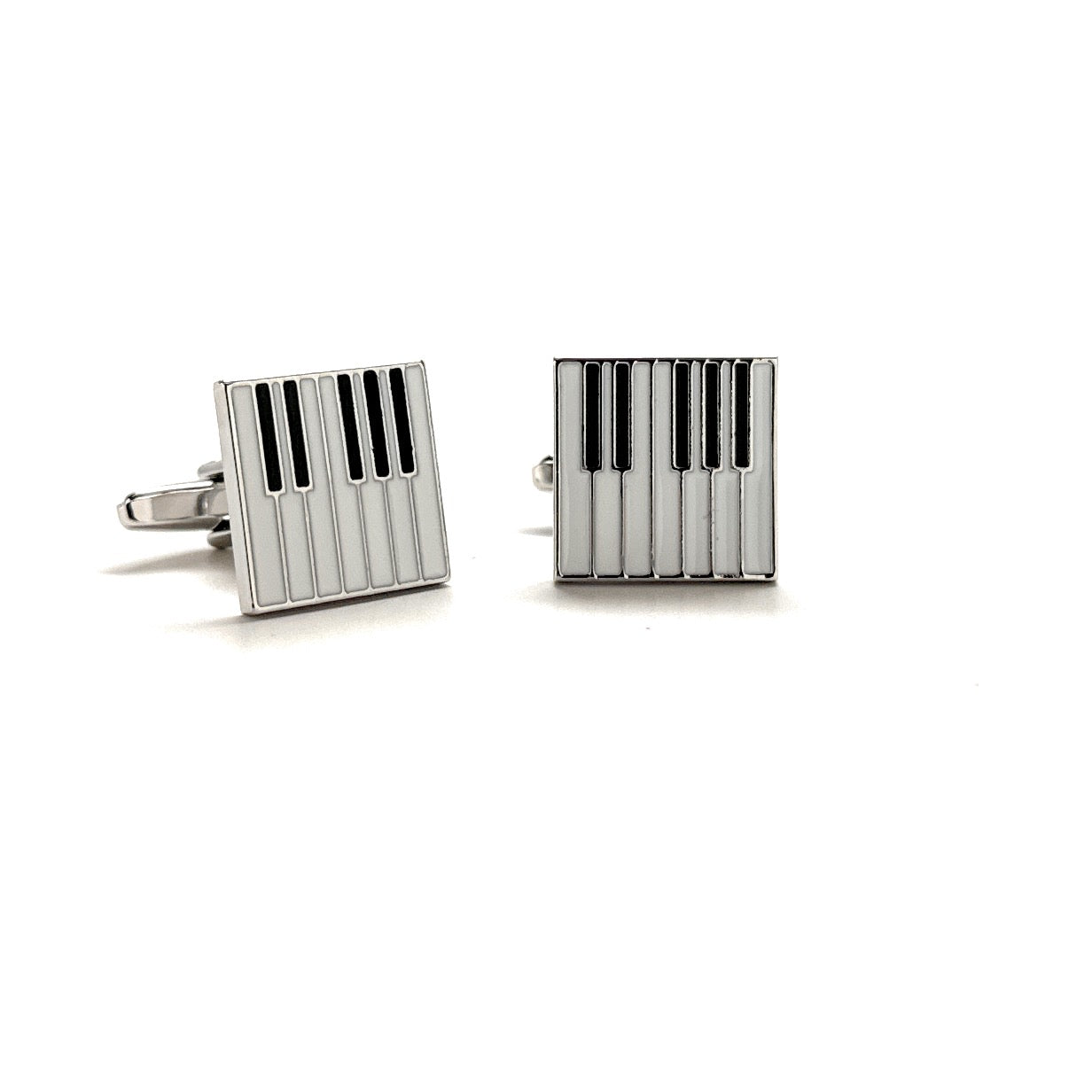Pair of silver cufflinks with black stripes on a white background
