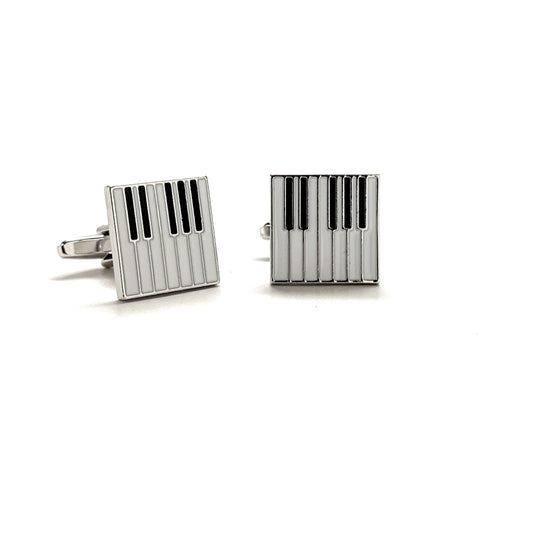 Pair of silver cufflinks with black stripes on a white background