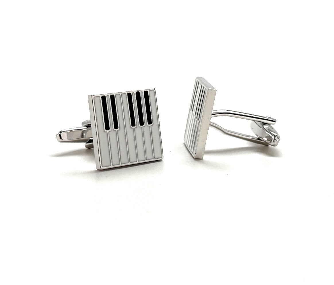 Pair of silver cufflinks with rectangular design on a white background