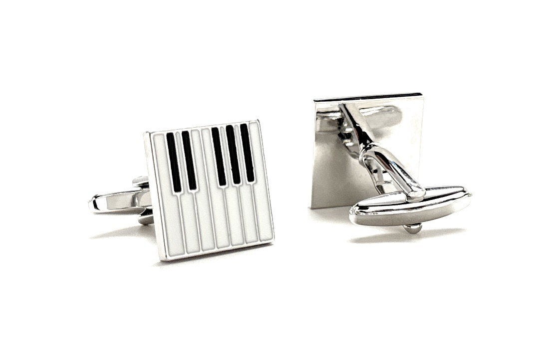 Silver cufflinks with geometric design on a white background