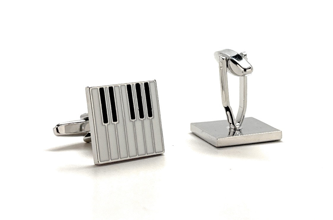 Silver cufflinks with a rectangular design on a white background