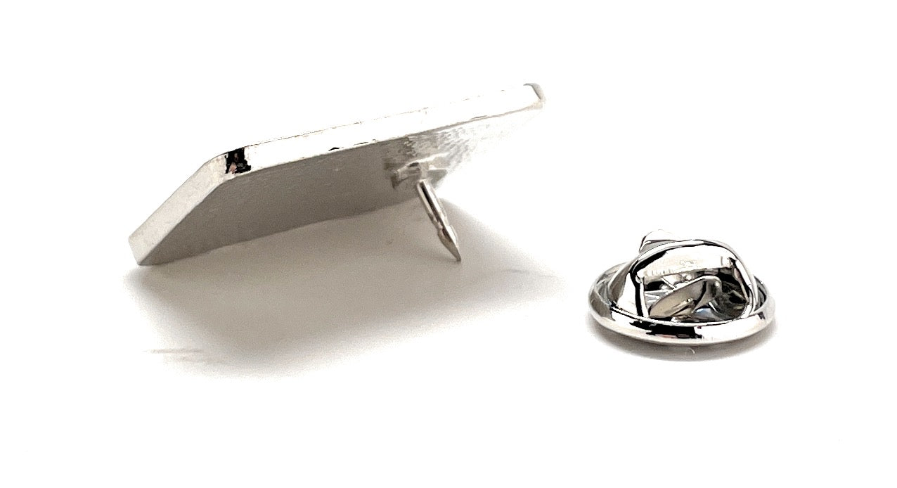 Metallic lapel pin on a white background
