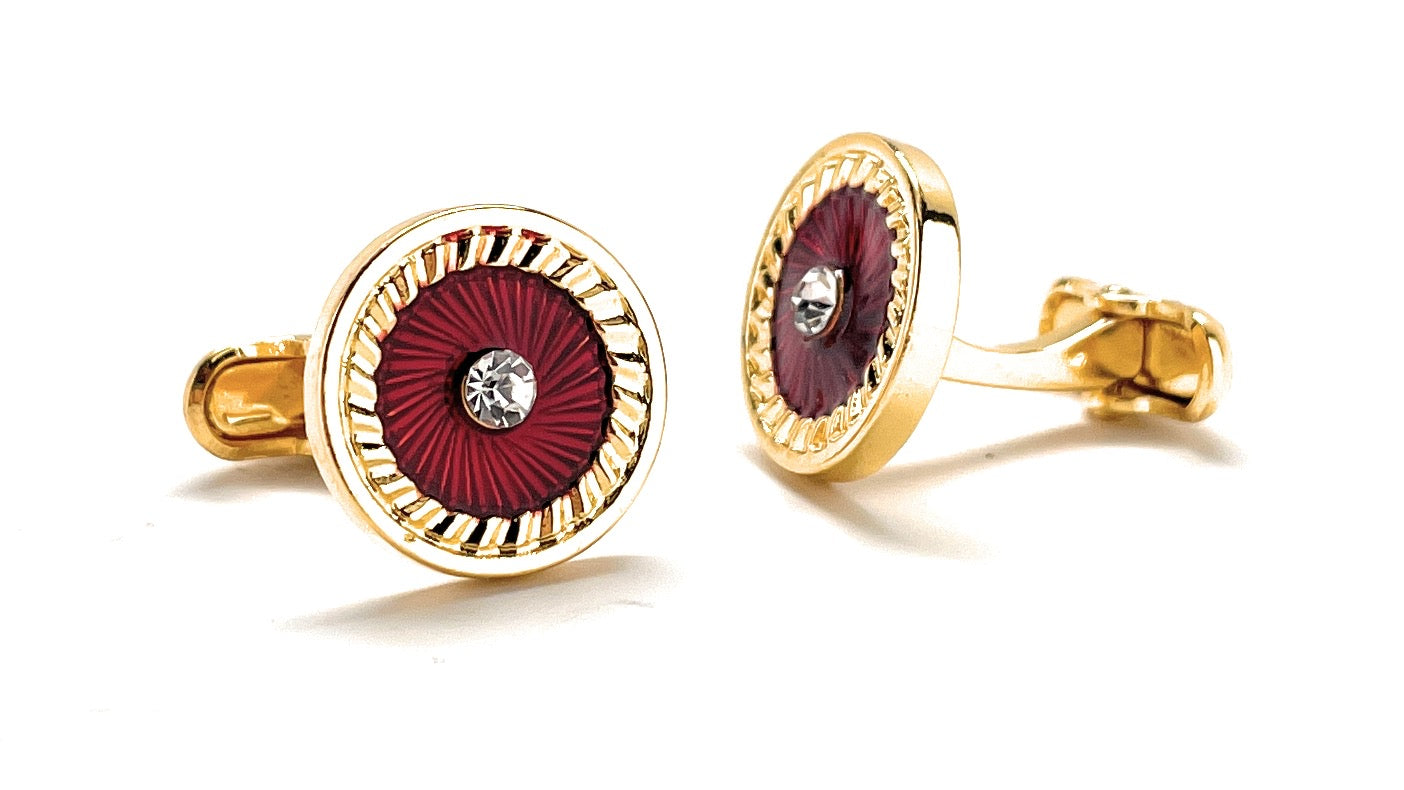 Gold and red earrings on a white background