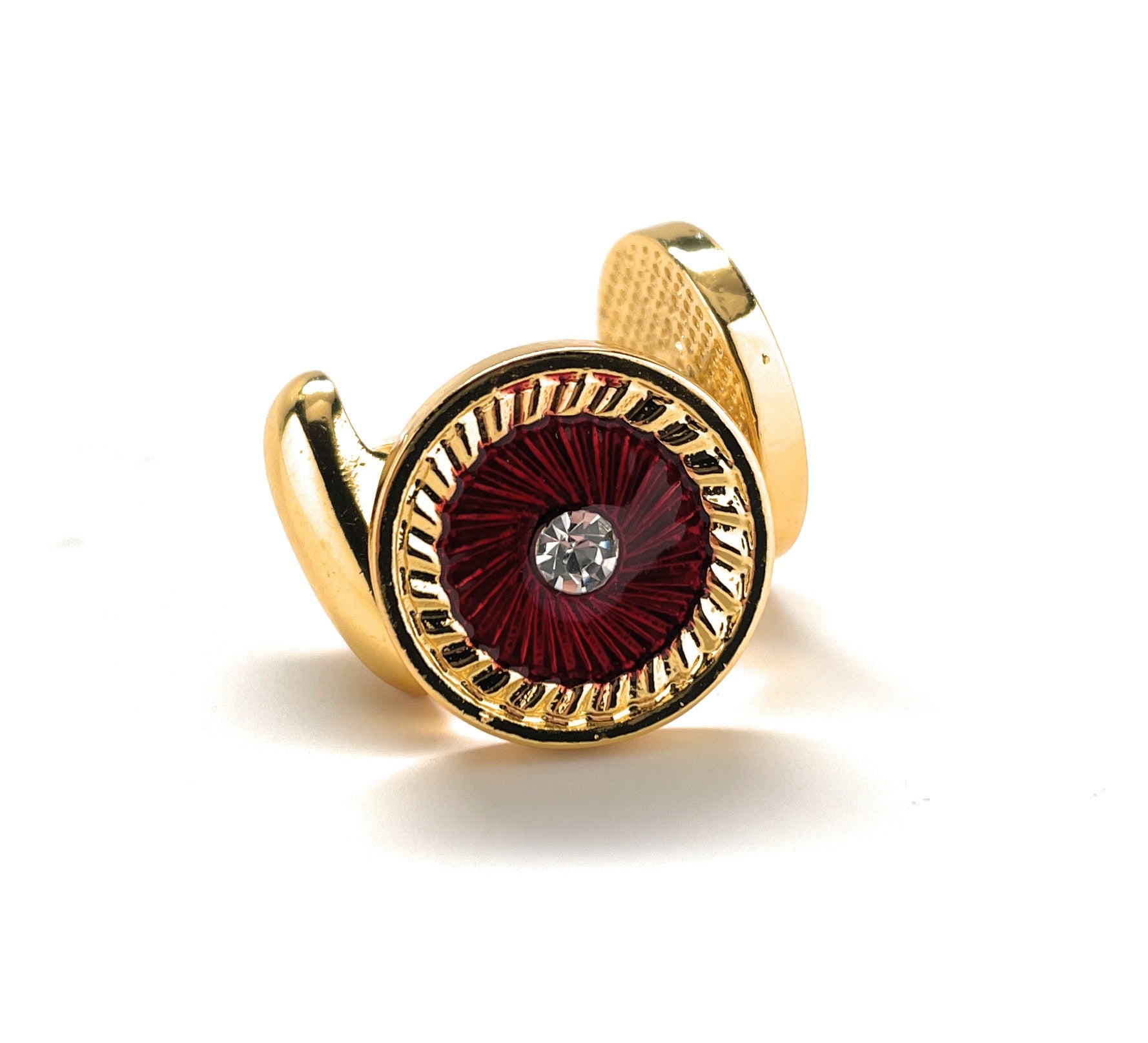 Gold ring with a red gemstone on a white background
