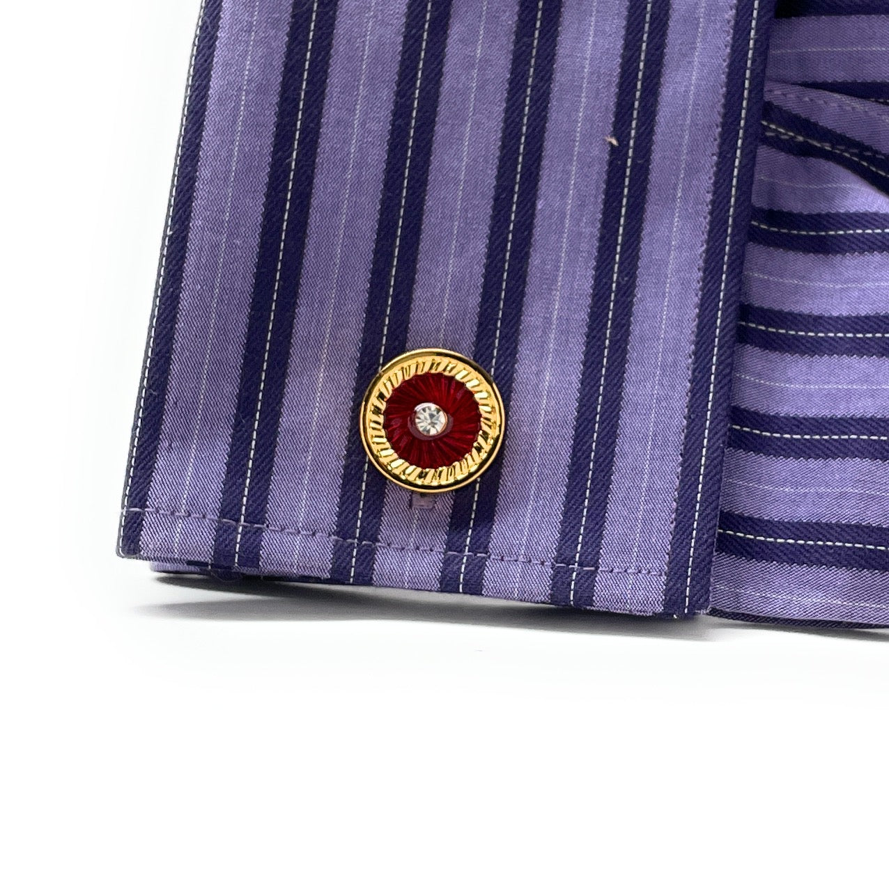 Close-up of a purple striped shirt with a decorative button on a white background