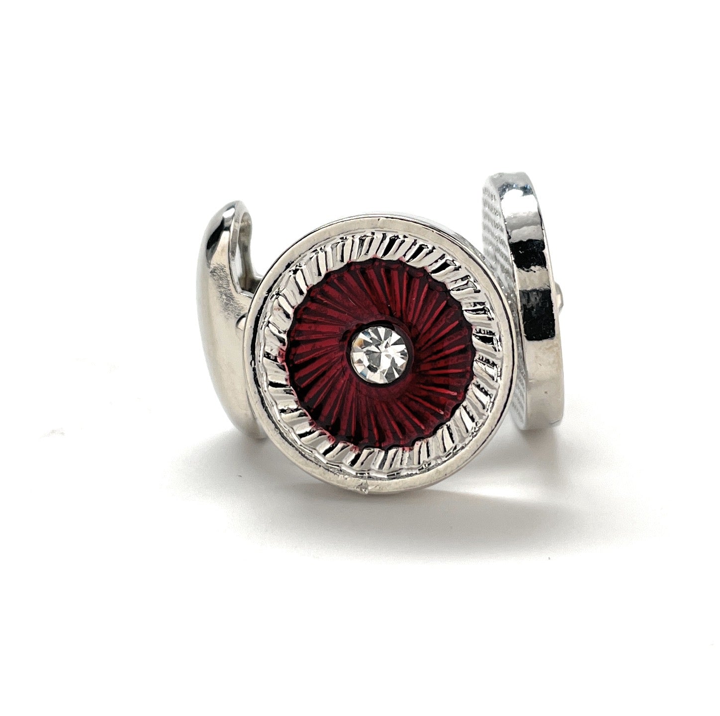 Silver ring with a red gemstone on a white background