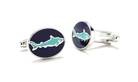 Cufflinks with shark design on a white background