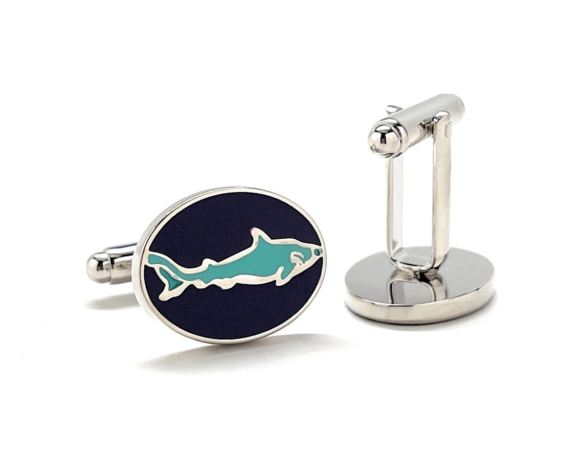 Cufflinks with a shark design on a navy background