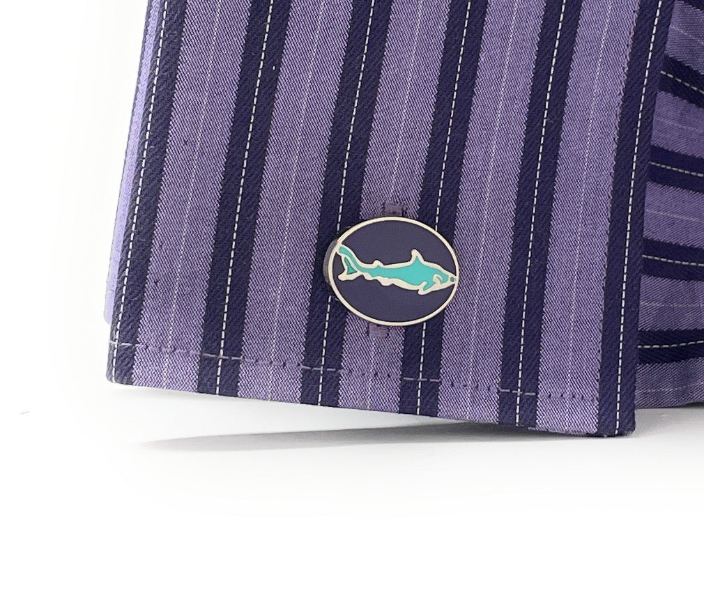 Close-up of purple striped fabric with a shark logo emblem on a white background
