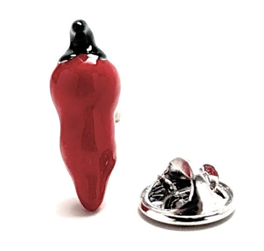 Red pepper-shaped lapel pin with black top on a white background