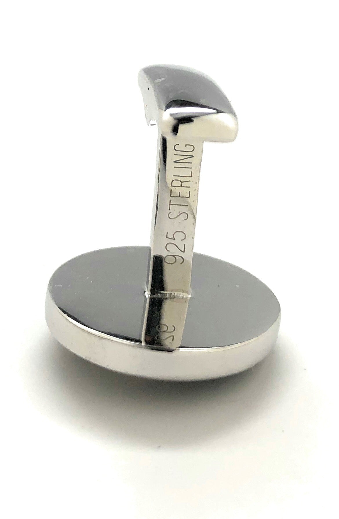 Silver ring with '925 Sterling' engraving on a white background