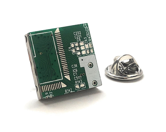 Small green circuit board with a metal pin on a white background