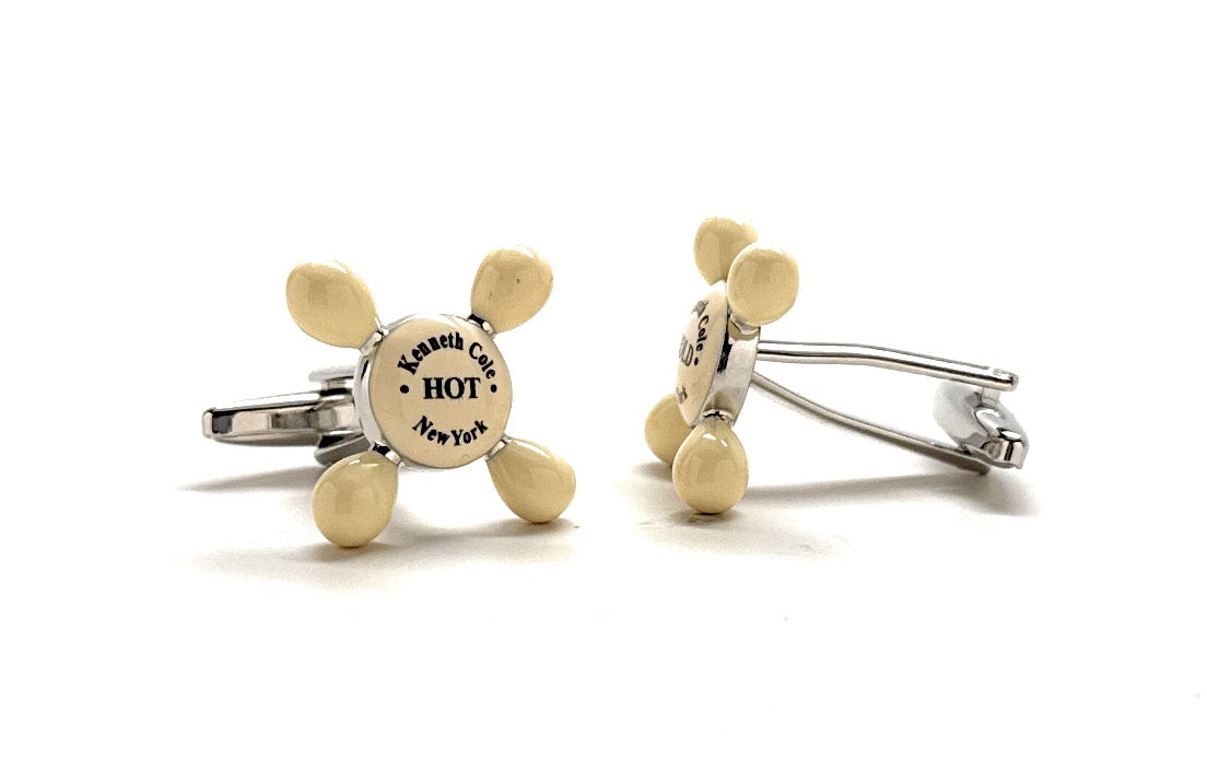 Pair of gold and silver cufflinks on a white background