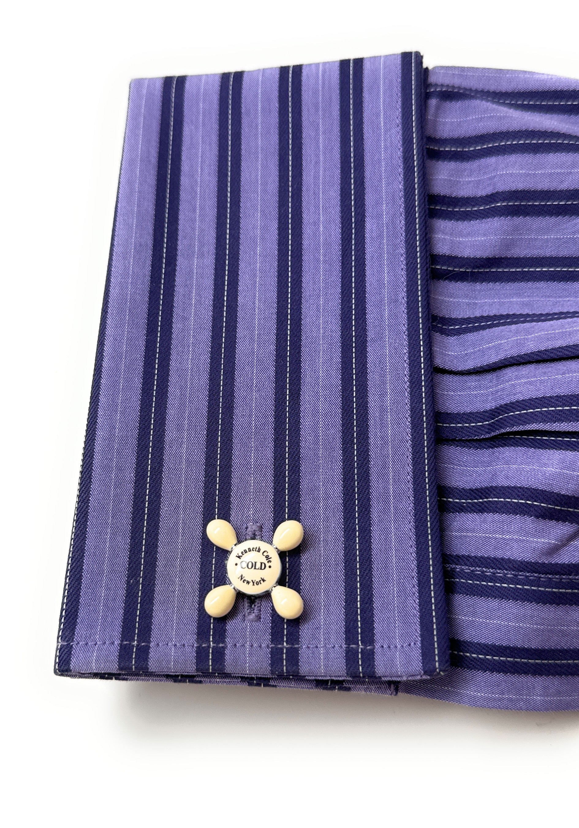 Purple striped fabric with a button on a white background