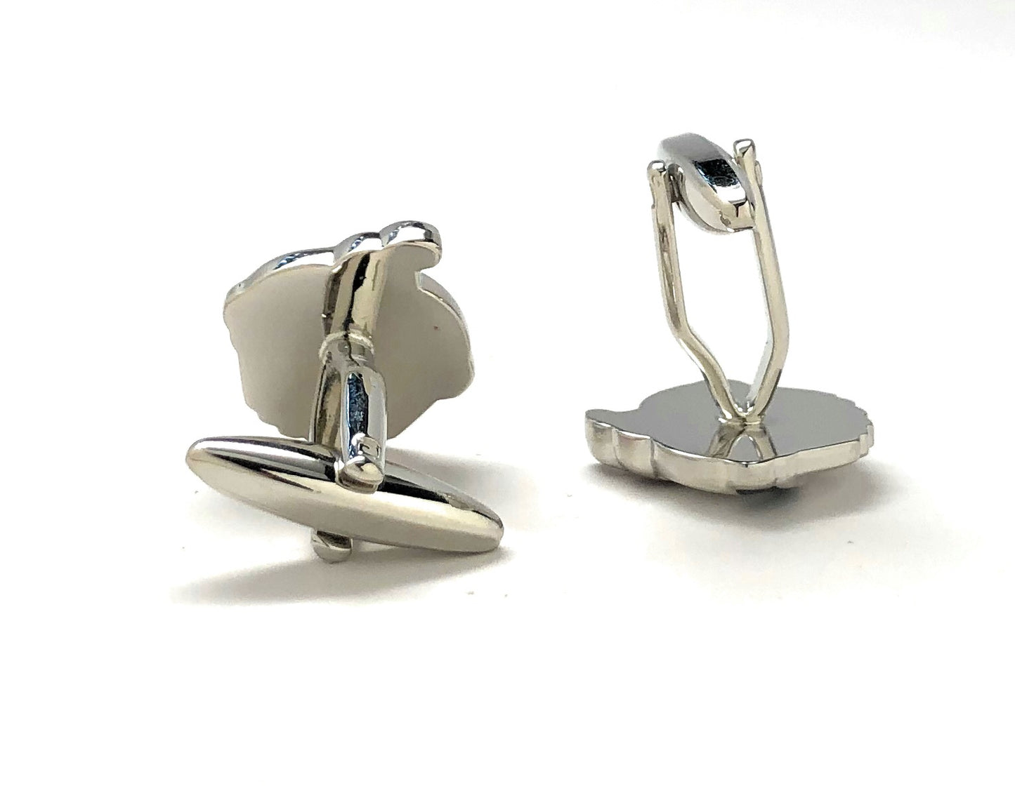Silver cufflinks on a white background