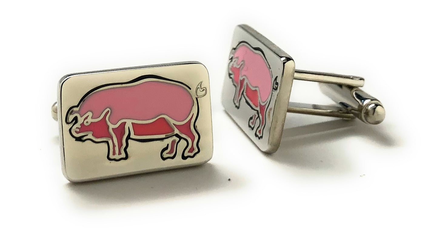Cufflinks with pink pig design on a white background