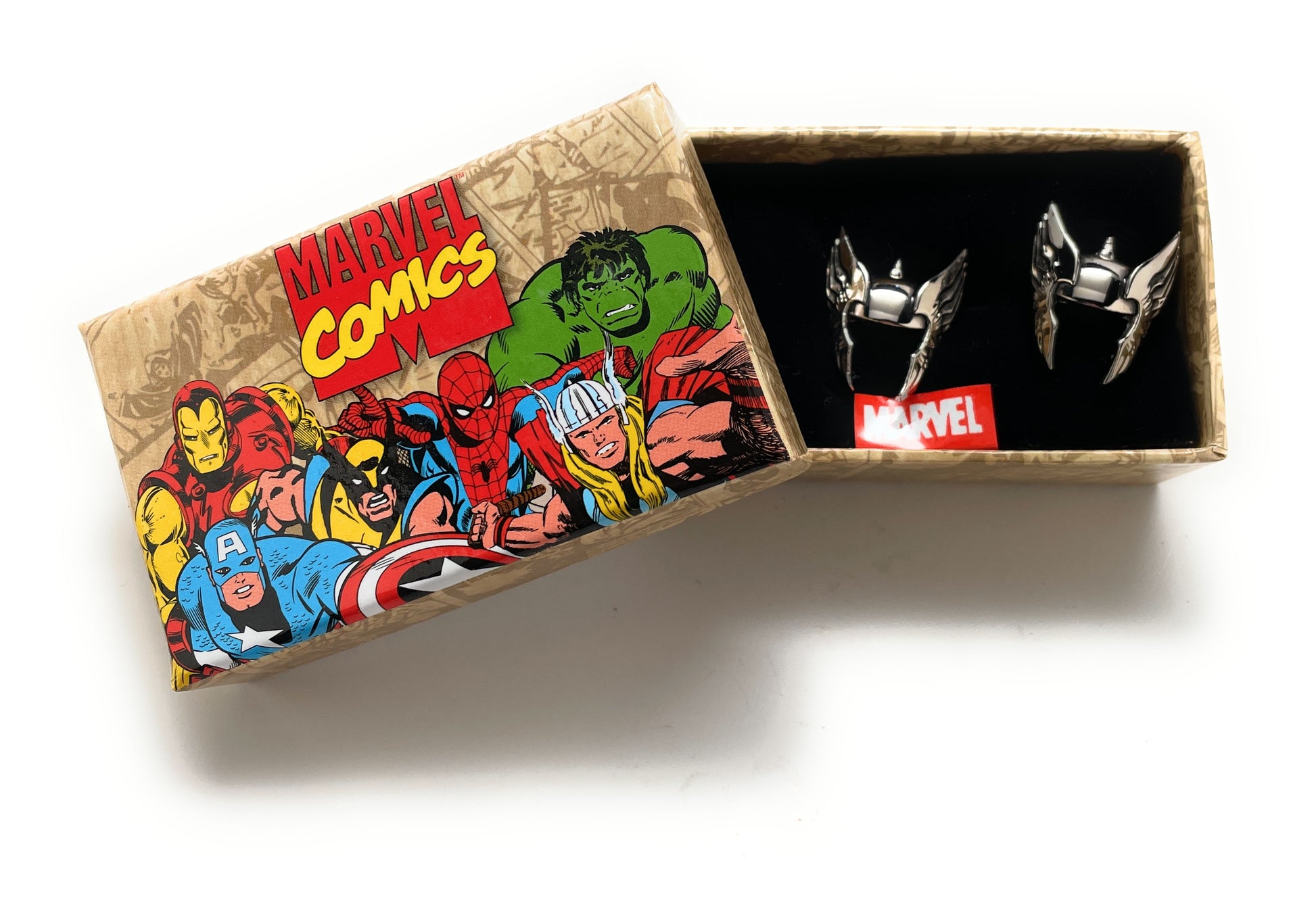 Marvel Comics-themed jewelry box with superhero illustrations and a pair of earrings inside.