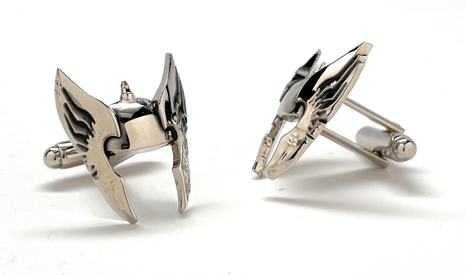 Pair of silver arrowhead-shaped cufflinks on a white background