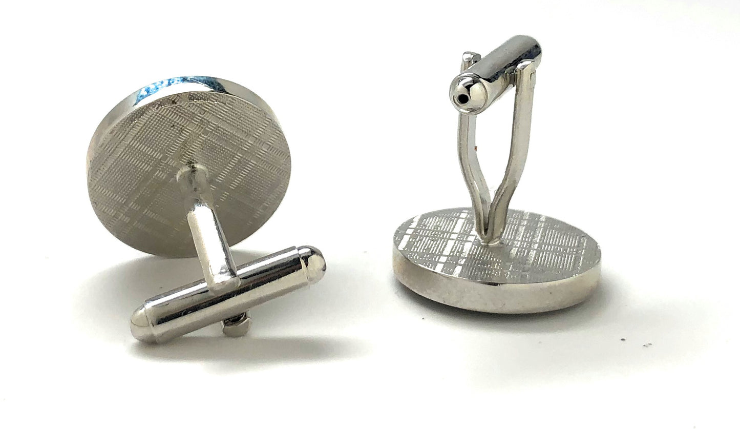 Silver cufflinks with textured design on a white background