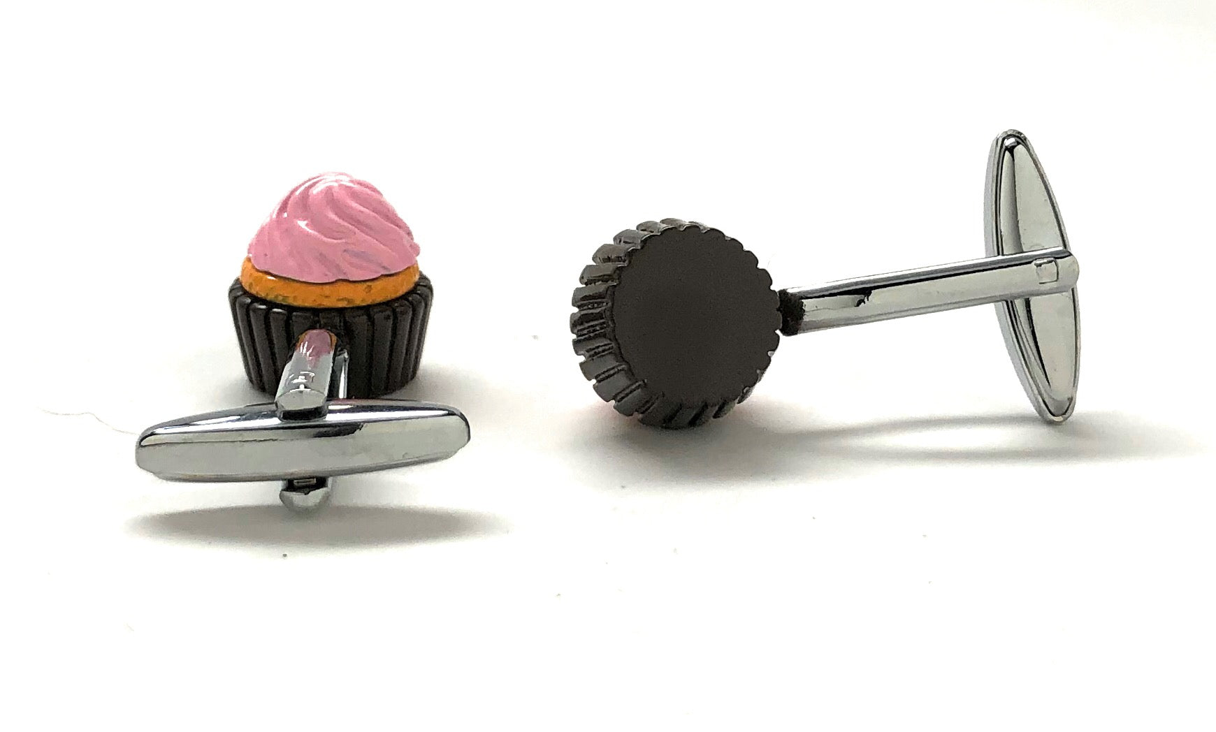 Cufflinks shaped like a cupcake with pink frosting on a white background