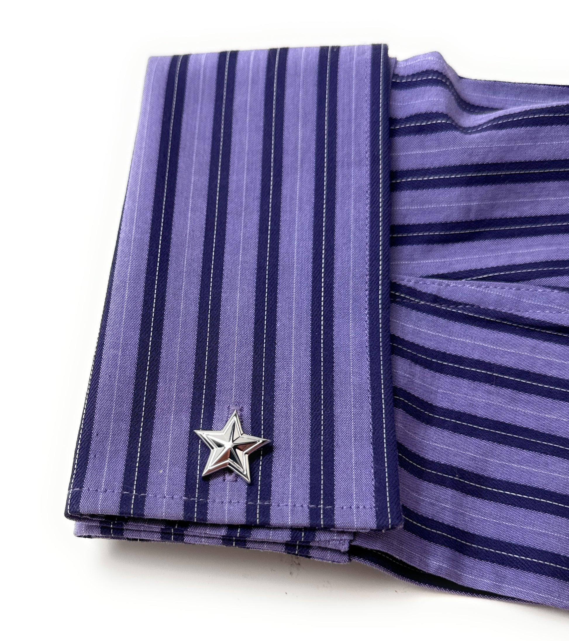 Purple striped shirt with a star-shaped cufflink on a white background