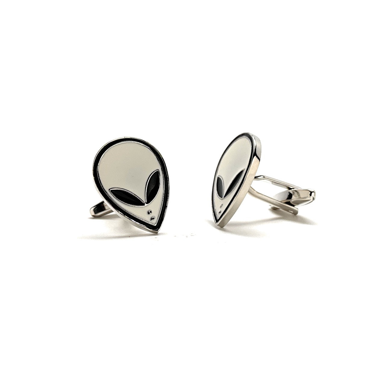 Silver alien head cufflinks on a white background