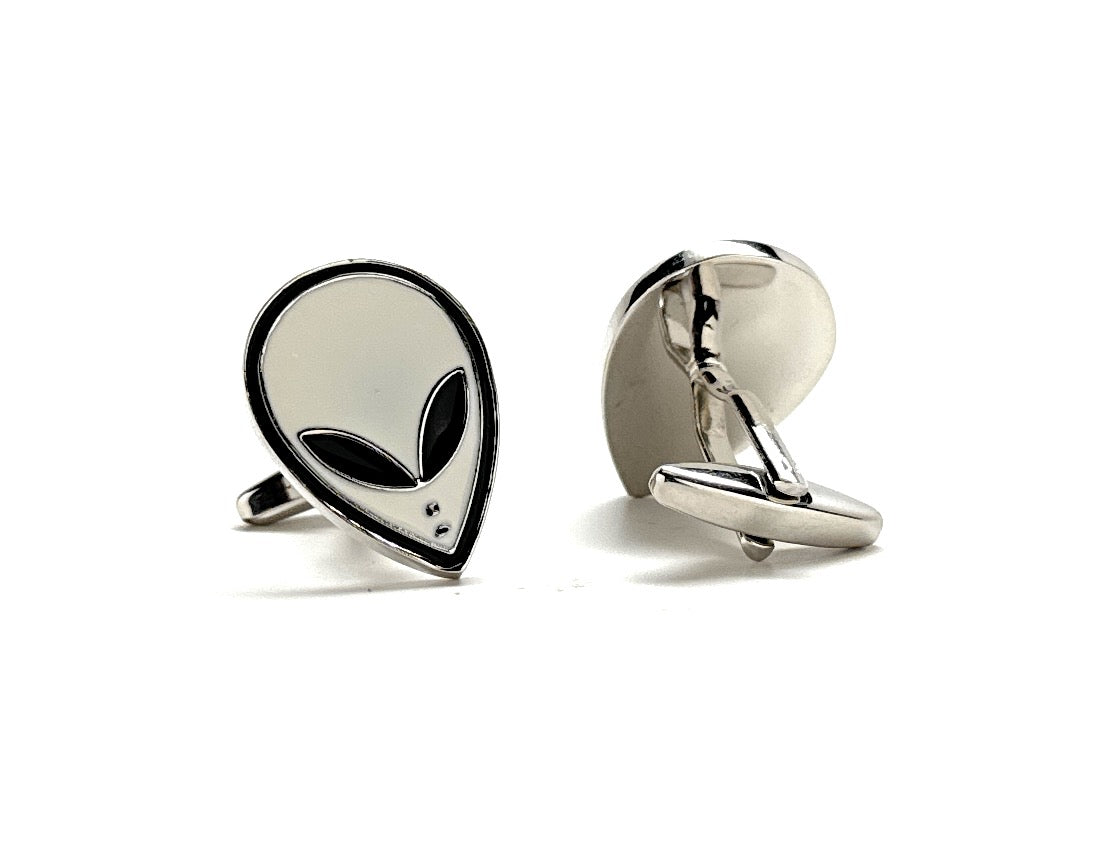 Silver alien head cufflinks on a white background