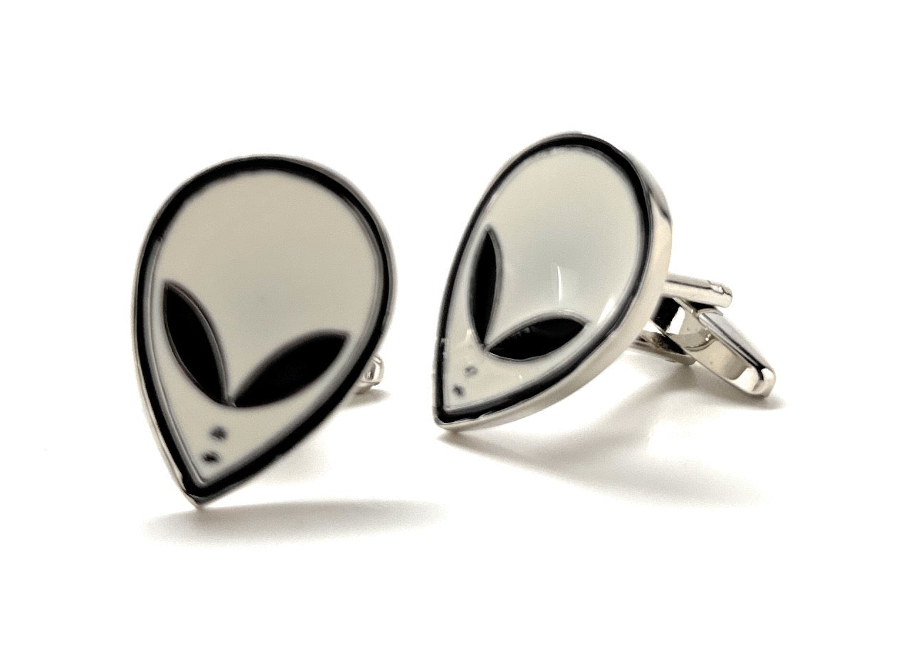 Alien head cufflinks on a white background