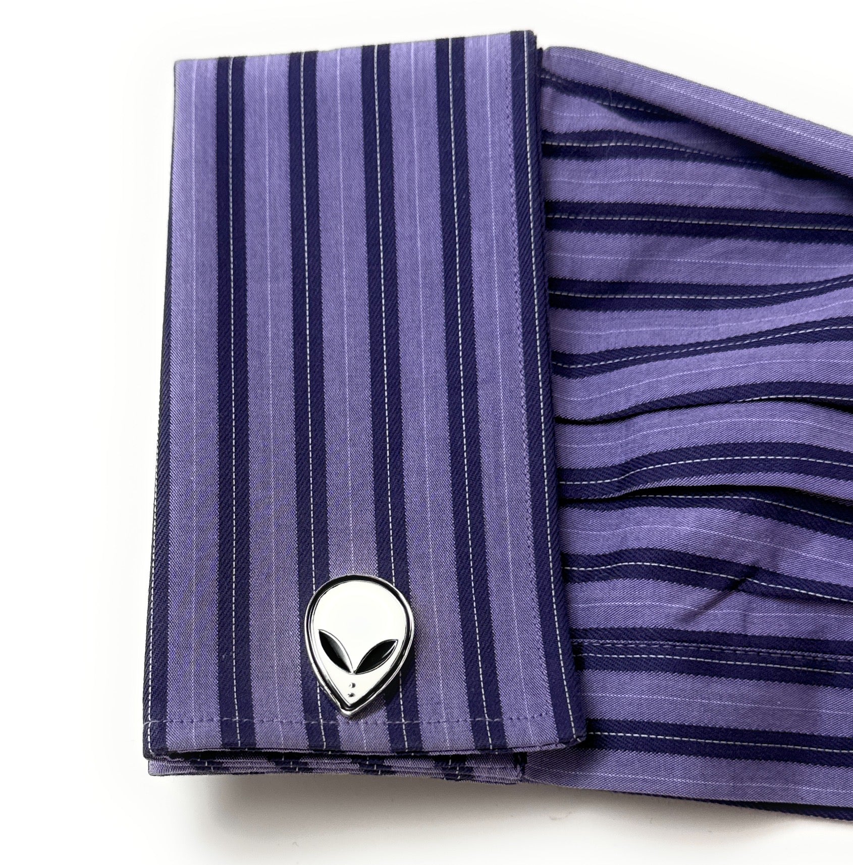 Purple striped fabric with alien head design on a white background