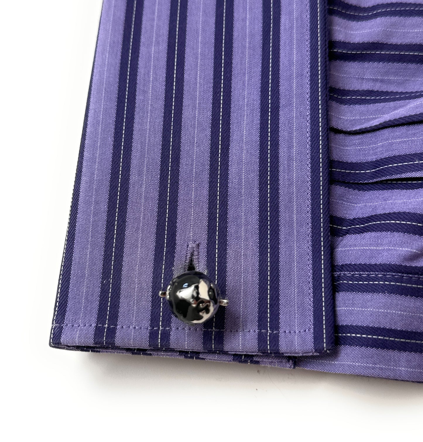 Silver and black spinning globe cufflinks with 3D rotating world design.