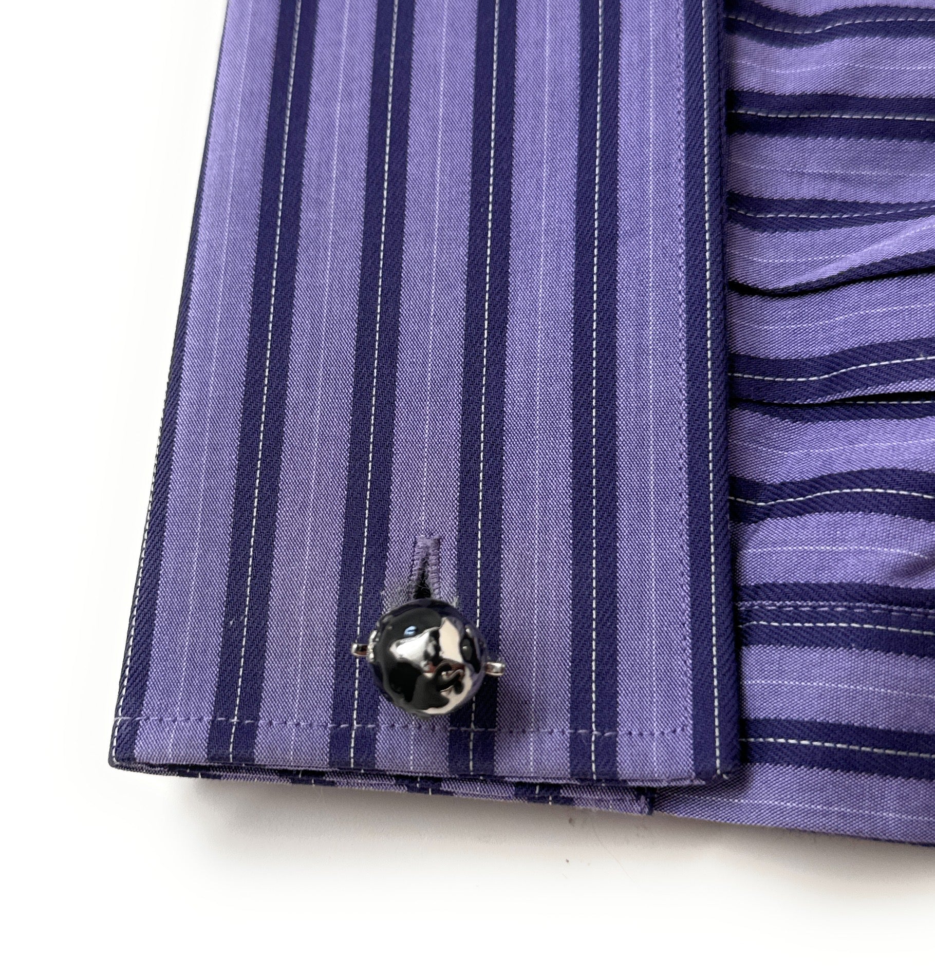 Silver and black spinning globe cufflinks with 3D rotating world design.