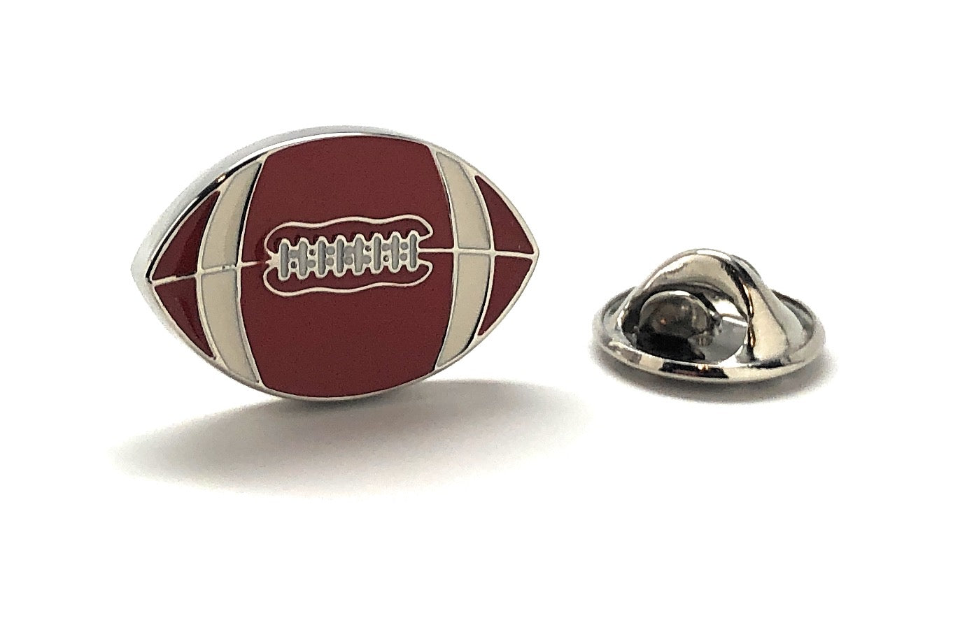 Football-shaped lapel pin with a metallic clasp on a white background