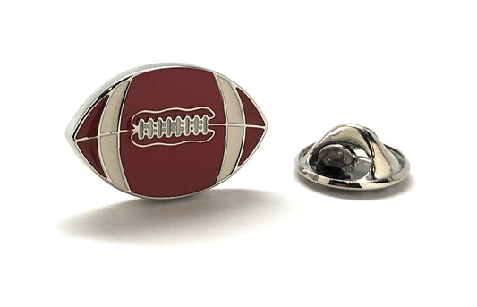 Football-shaped lapel pin with a metallic clasp on a white background