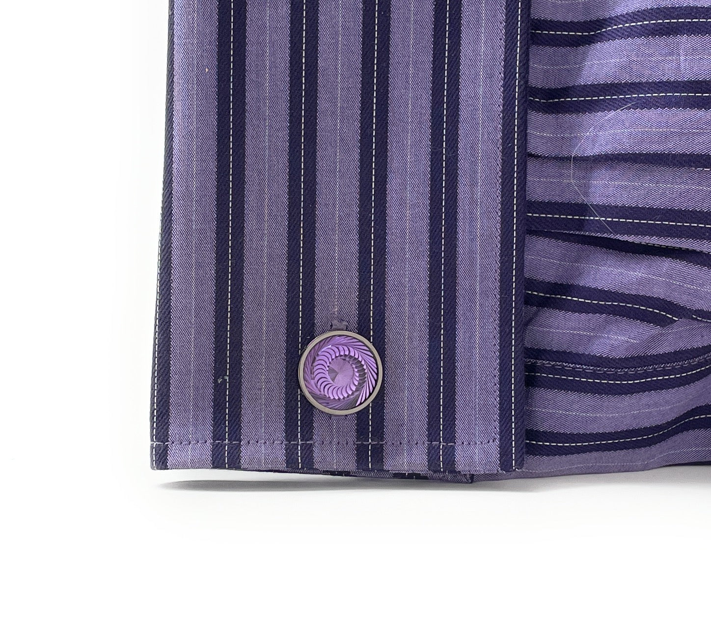 A pair of round silver and gunmetal cufflinks with a deep purple swirl pattern, known as the Purple Haze Cufflinks by JayPins, reflecting a bold and modern men’s fashion design.