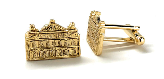 Gold cufflinks with architectural design on a white background