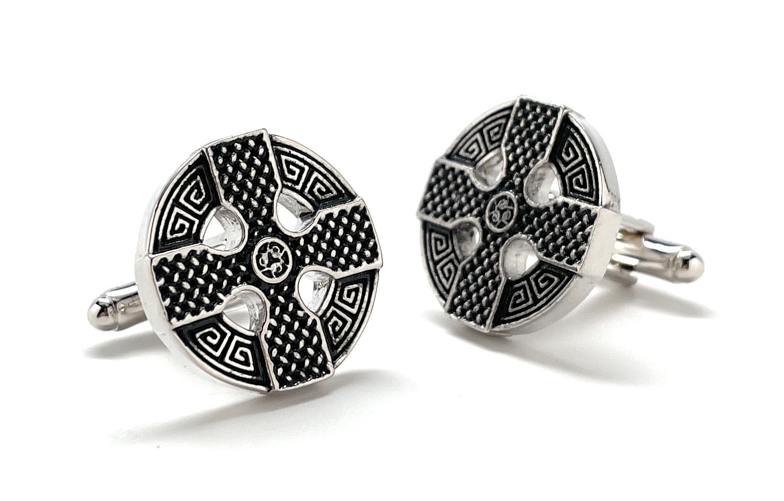Pair of silver and black patterned cufflinks on a white background