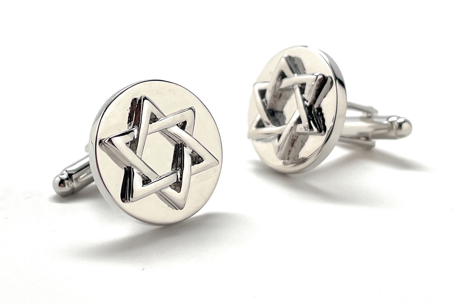 Silver cufflinks with Star of David design on a white background