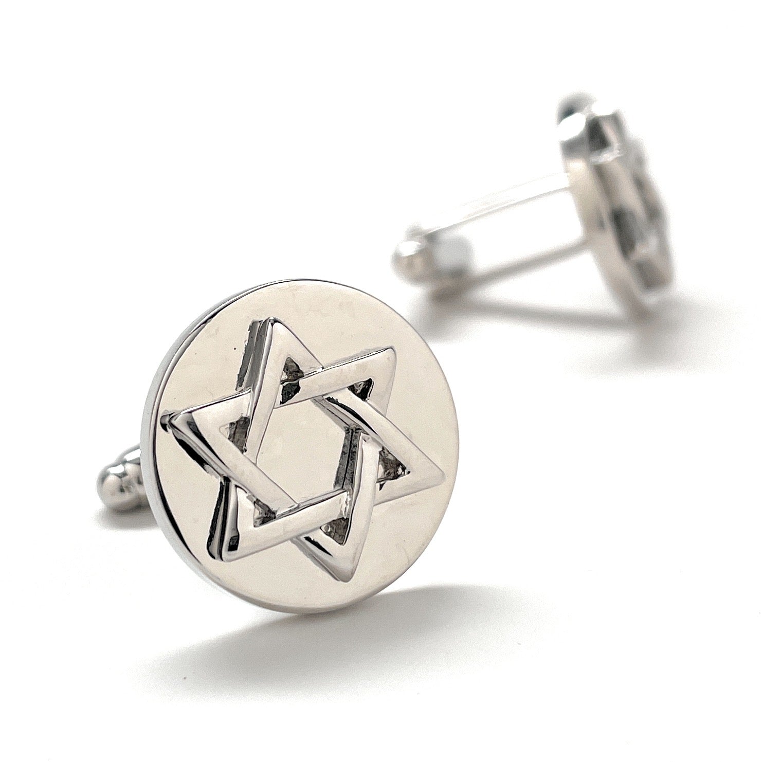 Silver cufflinks with Star of David design on a white background
