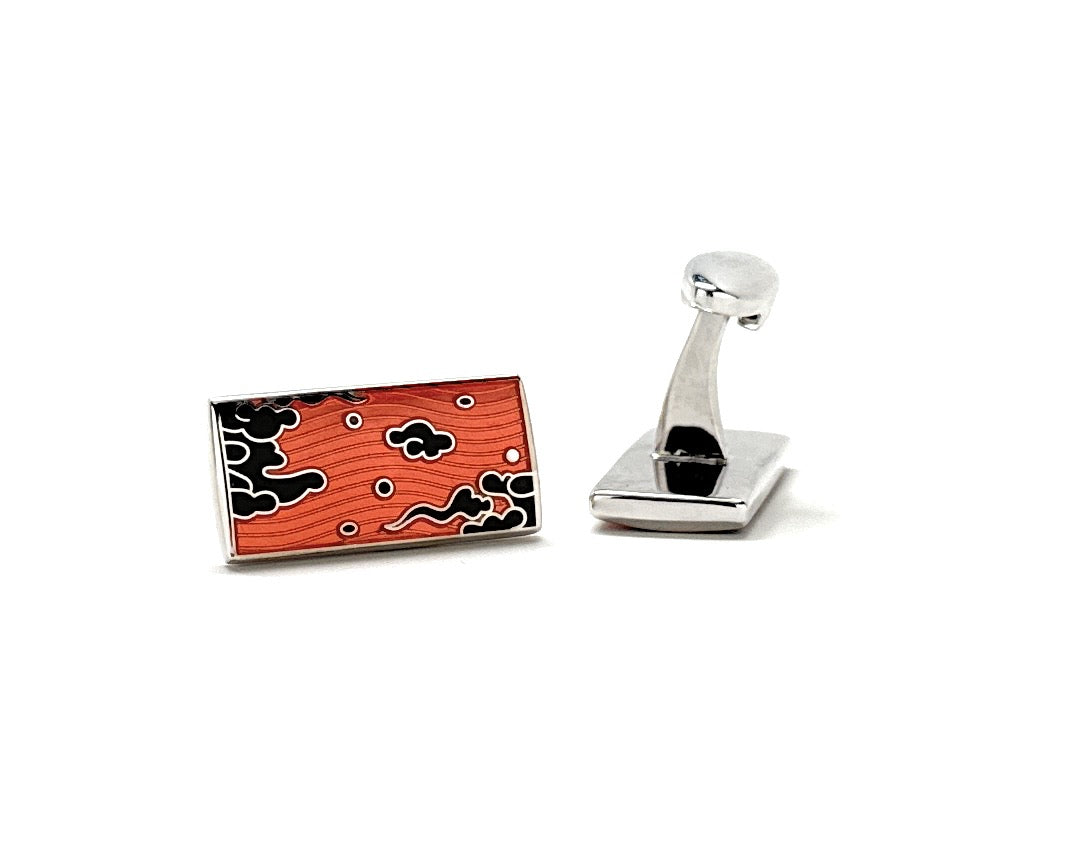 Cufflinks with a red and black design on a white background