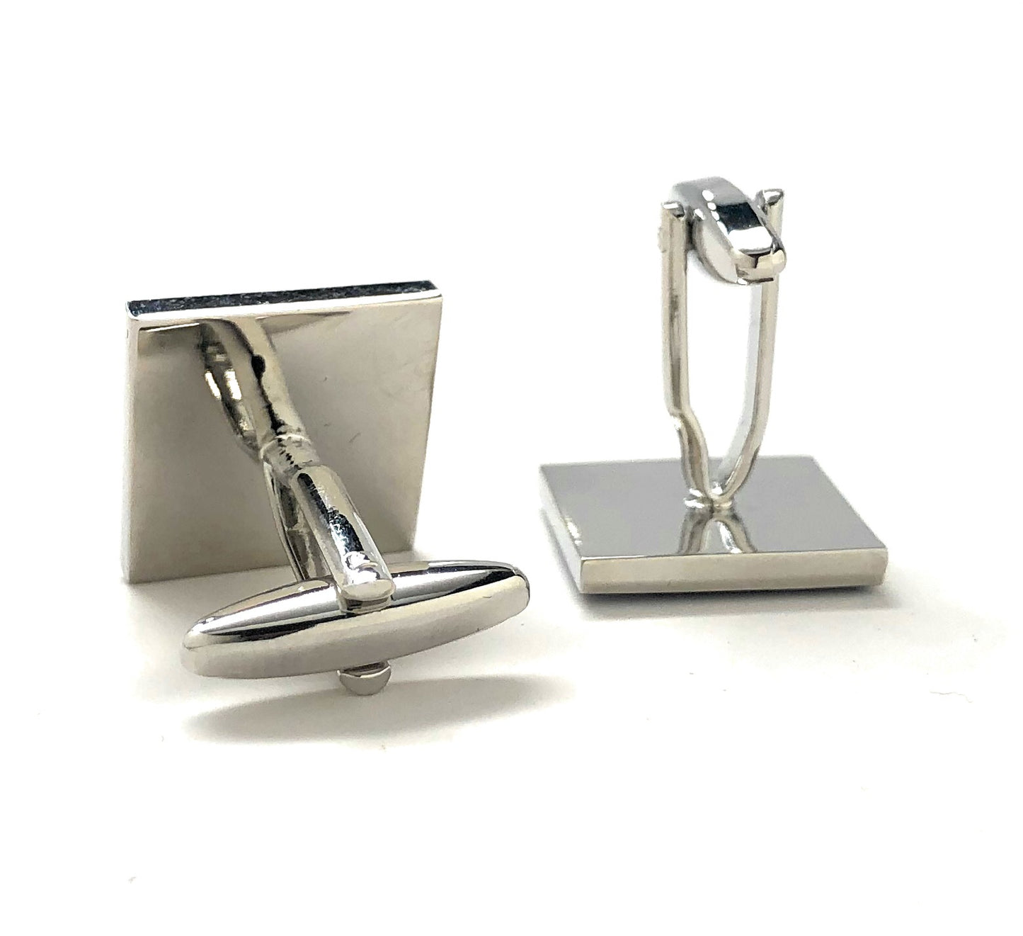 Silver cufflinks on a white background