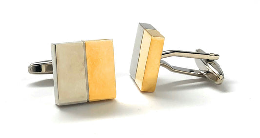 Two gold and silver square cufflinks on a white background