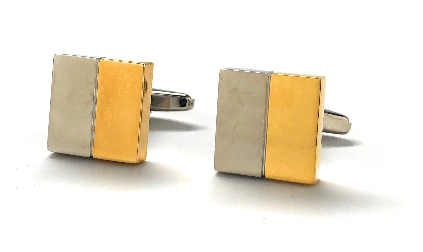 Pair of square cufflinks with gold and silver color scheme on a white background