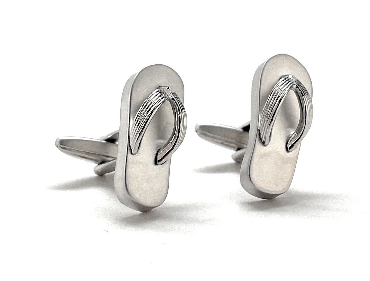 Silver flip-flop cufflinks on a white background