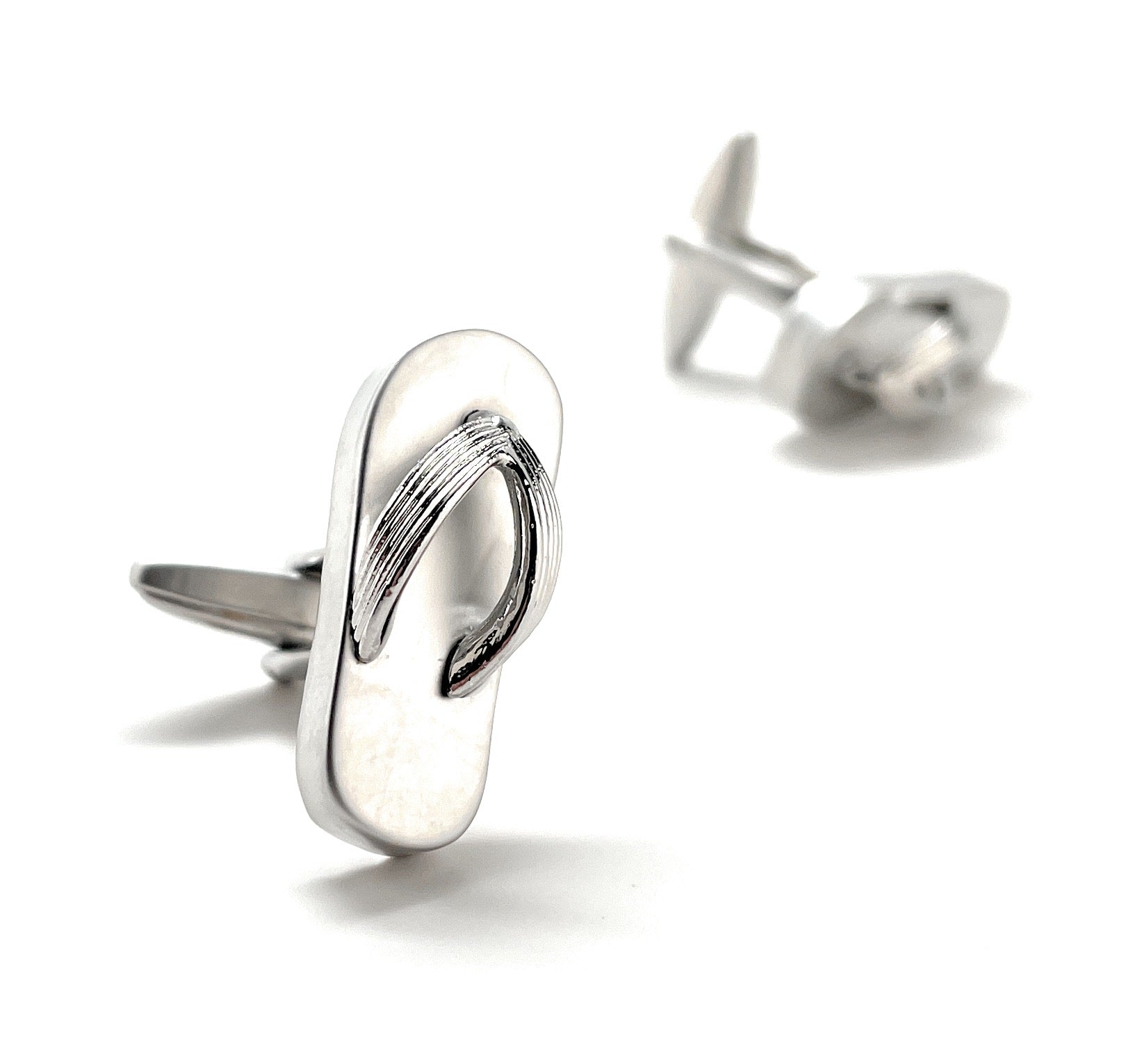 Silver flip-flop cufflinks on a white background