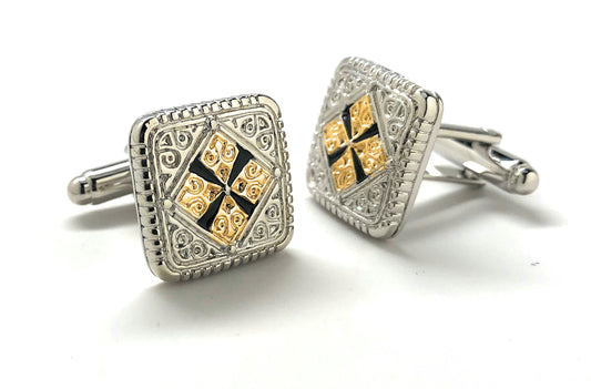 Pair of silver and gold cufflinks on a white background