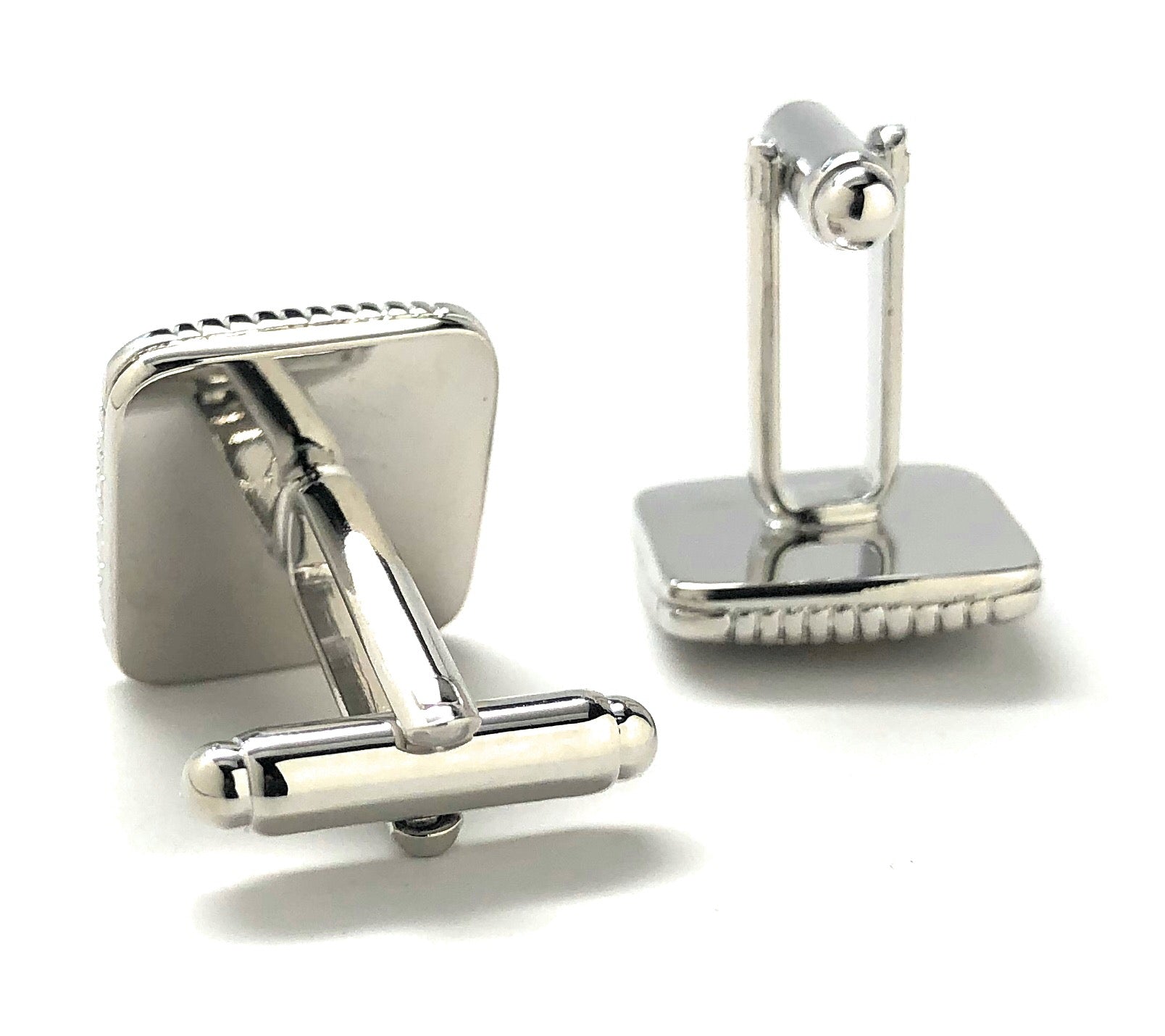 Pair of silver cufflinks on a white background