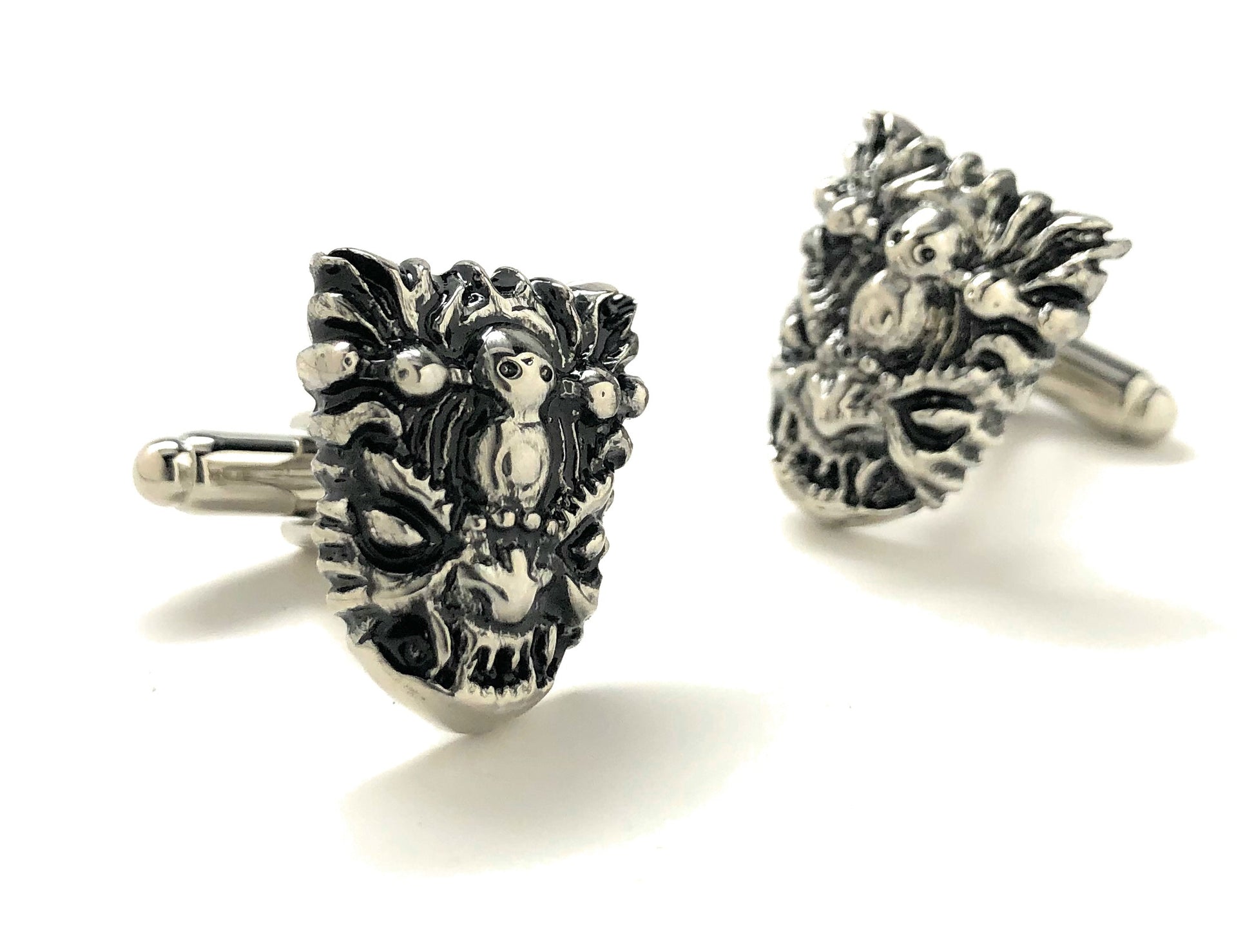 Pair of silver yeti head cufflinks on a white background