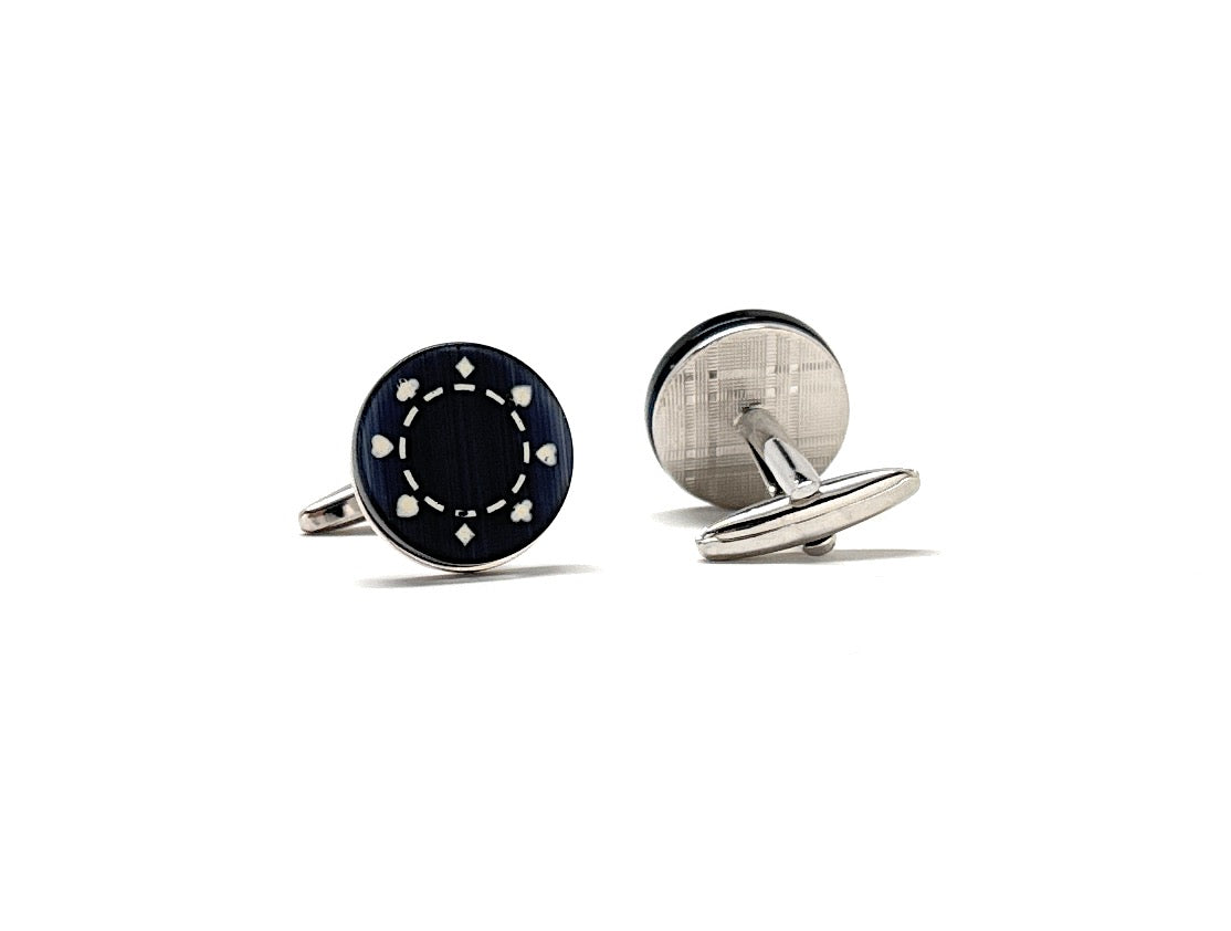 Two cufflinks, one black and one silver, on a white background