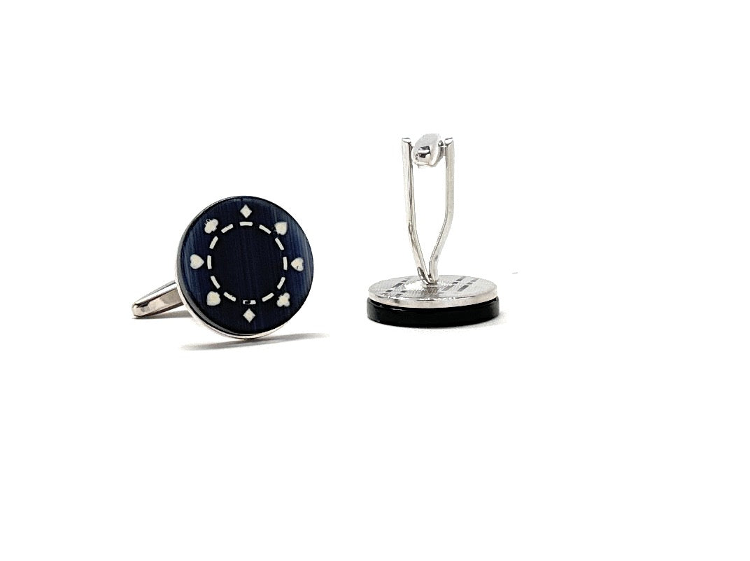 Pair of black cufflinks with silver accents on a white background